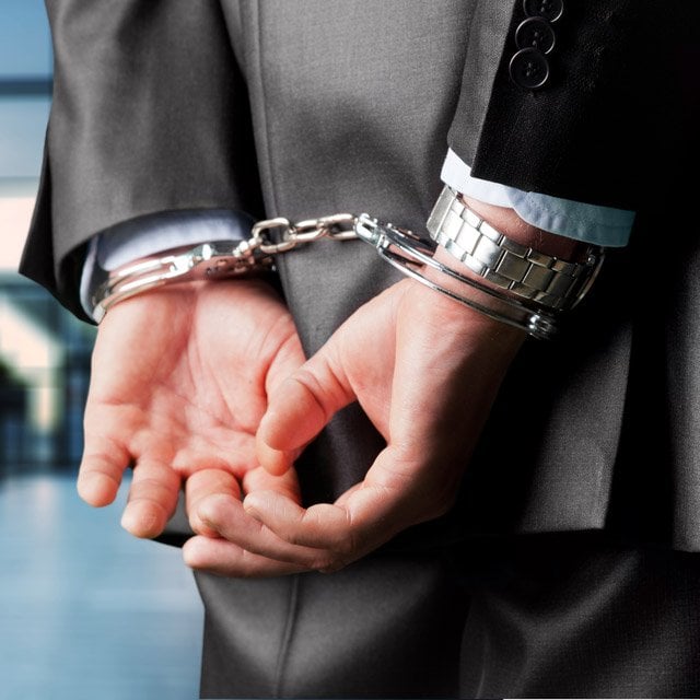 Businessman in handcuffs