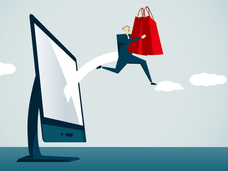 Shopping bag leaping from a computer to illustrate e-commerce growth for insurers