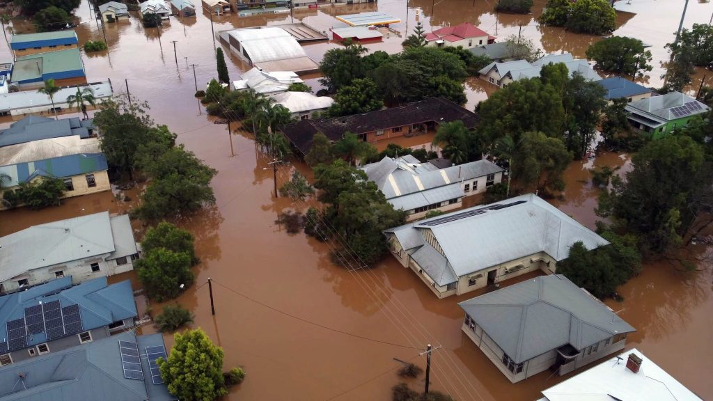 Aerial view of a small town with several houses completely flooded. Consequence of climate change.