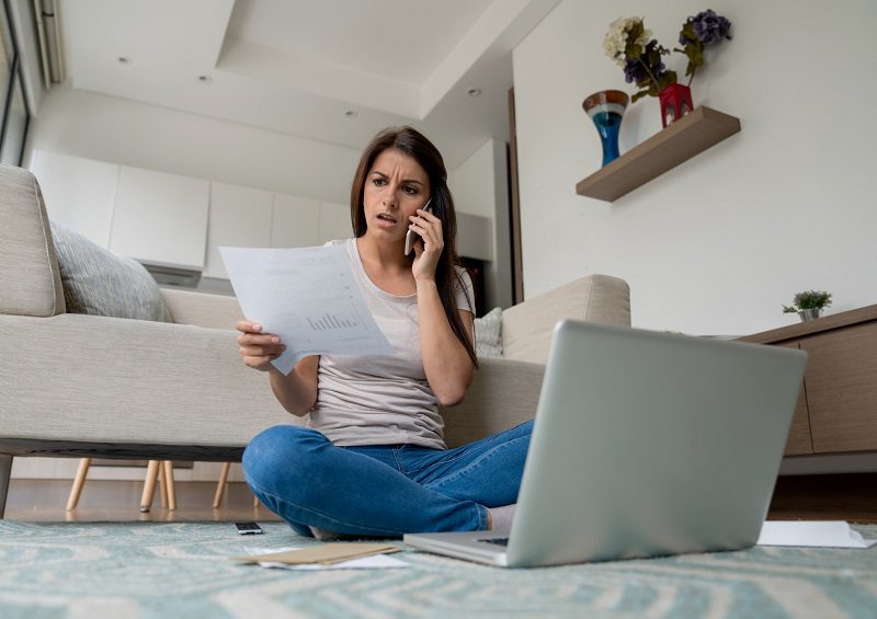 Woman at home complaining about a bill on the phone