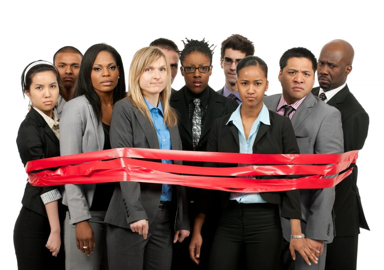 A diverse business team caught in red tape