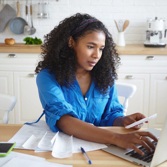 Woman paying bills, budgeting