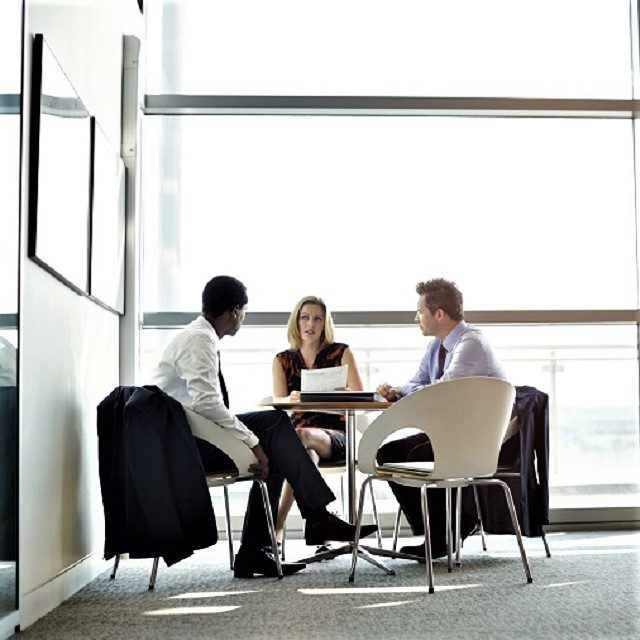 Clients sitting at a table with an advisor