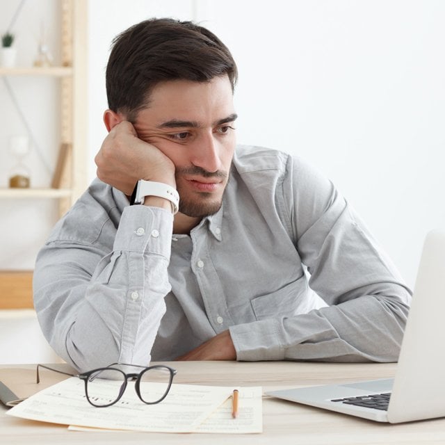 bored businessman at laptop