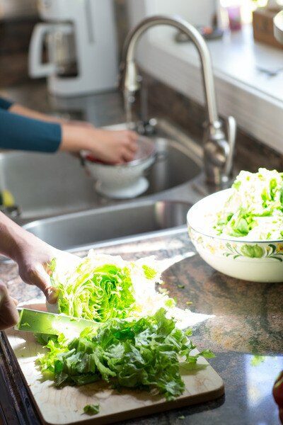 Hands Washing Lettuce In Sink