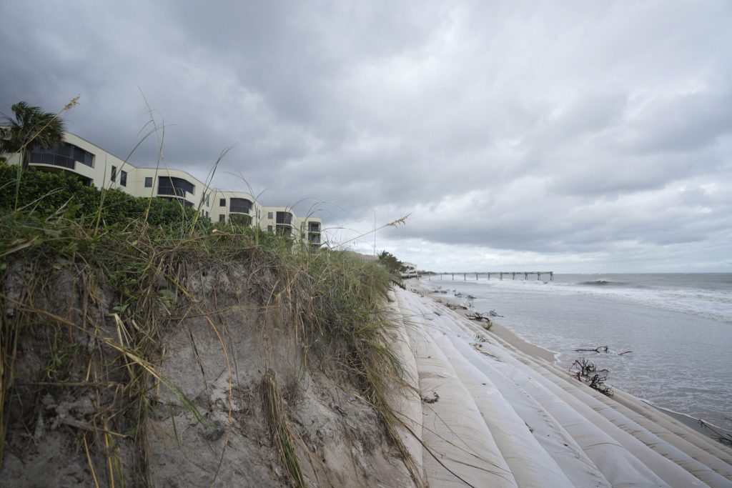 Sandbag beach reinforcements, which had previously been covered with sand, lie exposed following the passage of Hurricane Nicole, Thursday, Nov. 10, 2022, in Vero Beach, Fla. (AP Photo/Rebecca Blackwell)