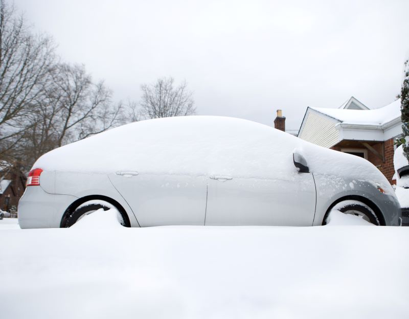 Cra in driveway covered with snow