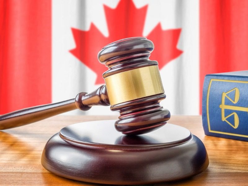 Gavel, law book and Canadian flag