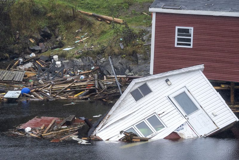 Buildings sit in the water in Rose Blanche-Harbour Le Cou