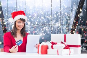 stockfresh_6129921_composite-image-of-festive-brunette-shopping-online-with-tablet_sizeS-300x200