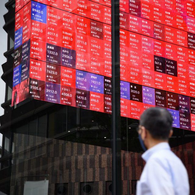 Man looking at a stock board