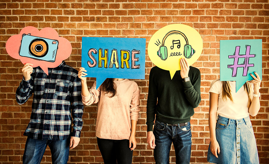 four people standing side by side holding social media icons over their faces