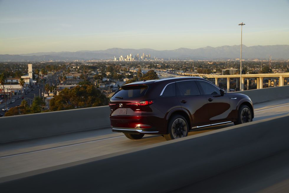 2024 mazda cx90 driving on an interstate