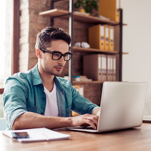 Man in casual clothing on a laptop