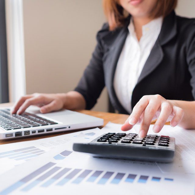 An accountant using a calculator