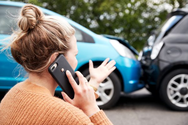 Woman on the phone after a car accident