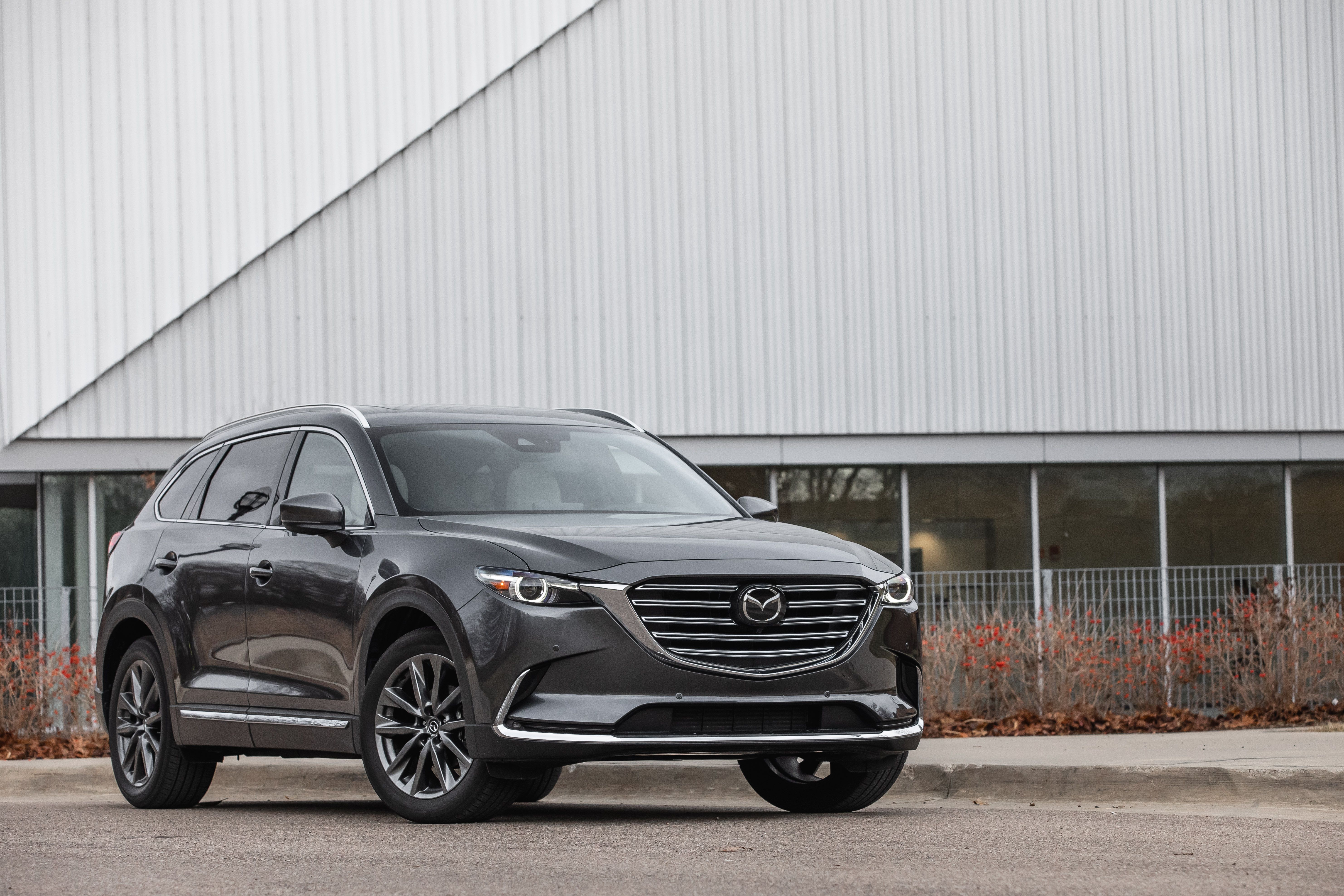 2023 charcoal gray mazda cx 9 suv parked near the sidewalk