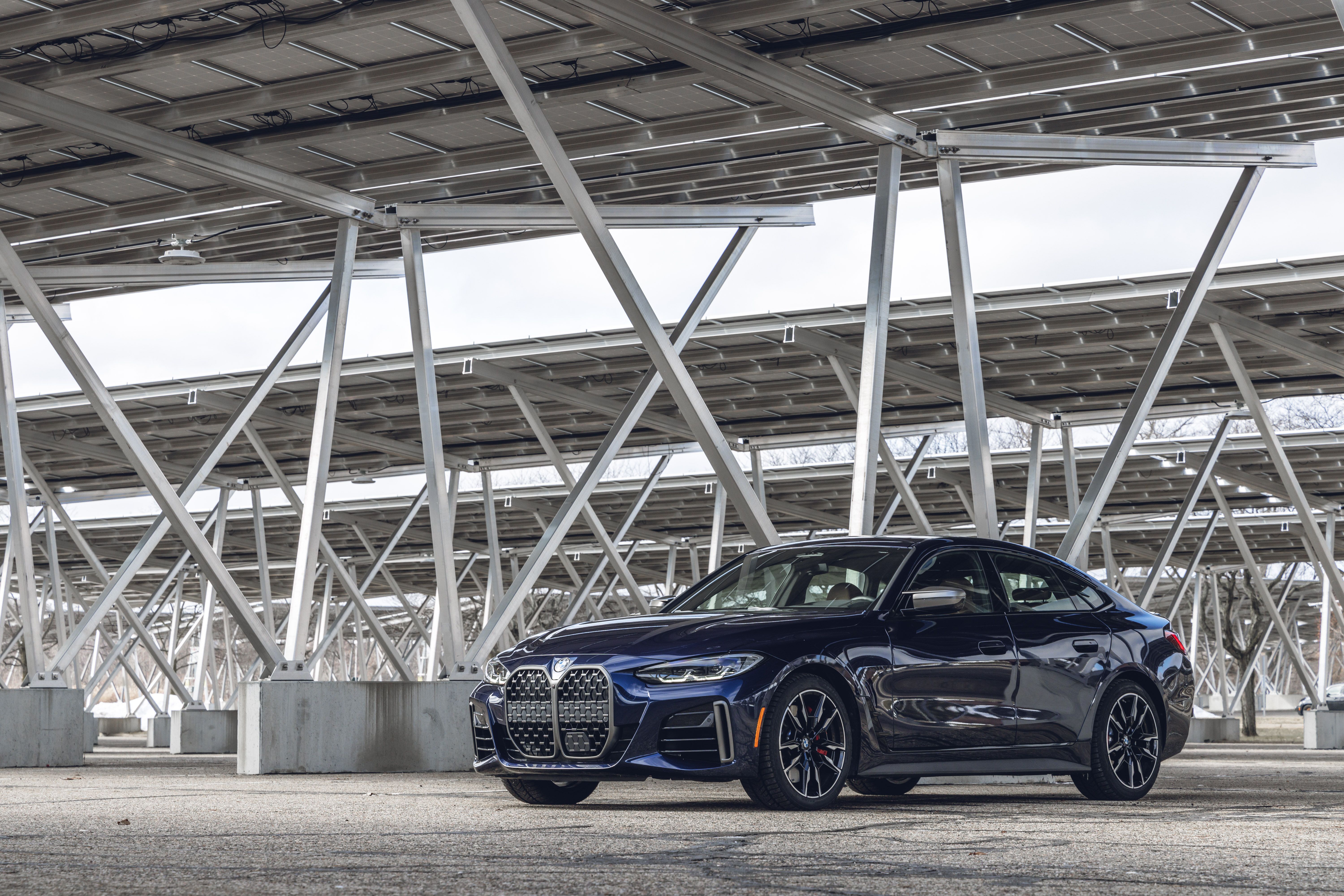 blue 2023 bmw 4series gran coupe parked underneath solar panels