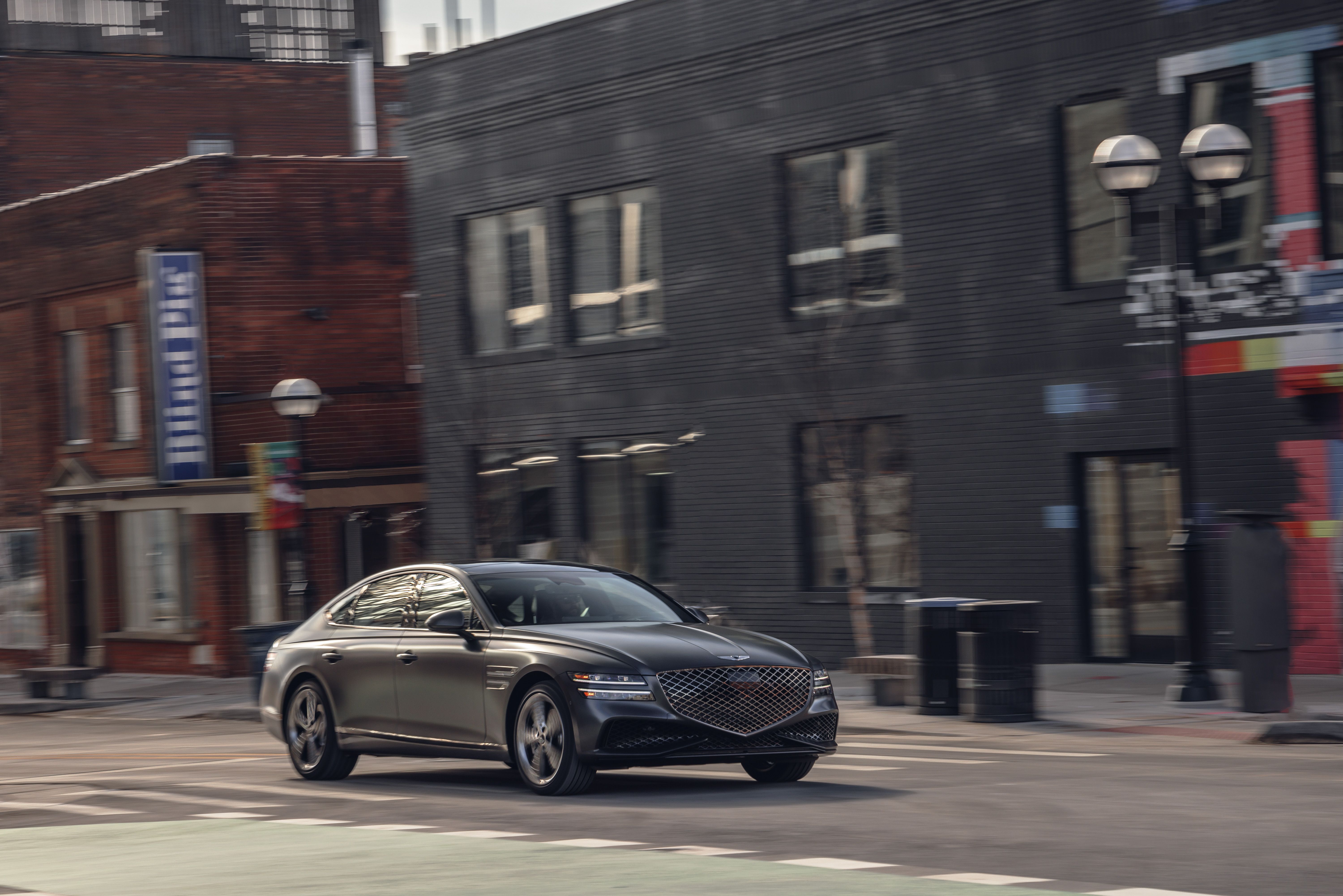 2023 genesis g80 sport driving through downtown