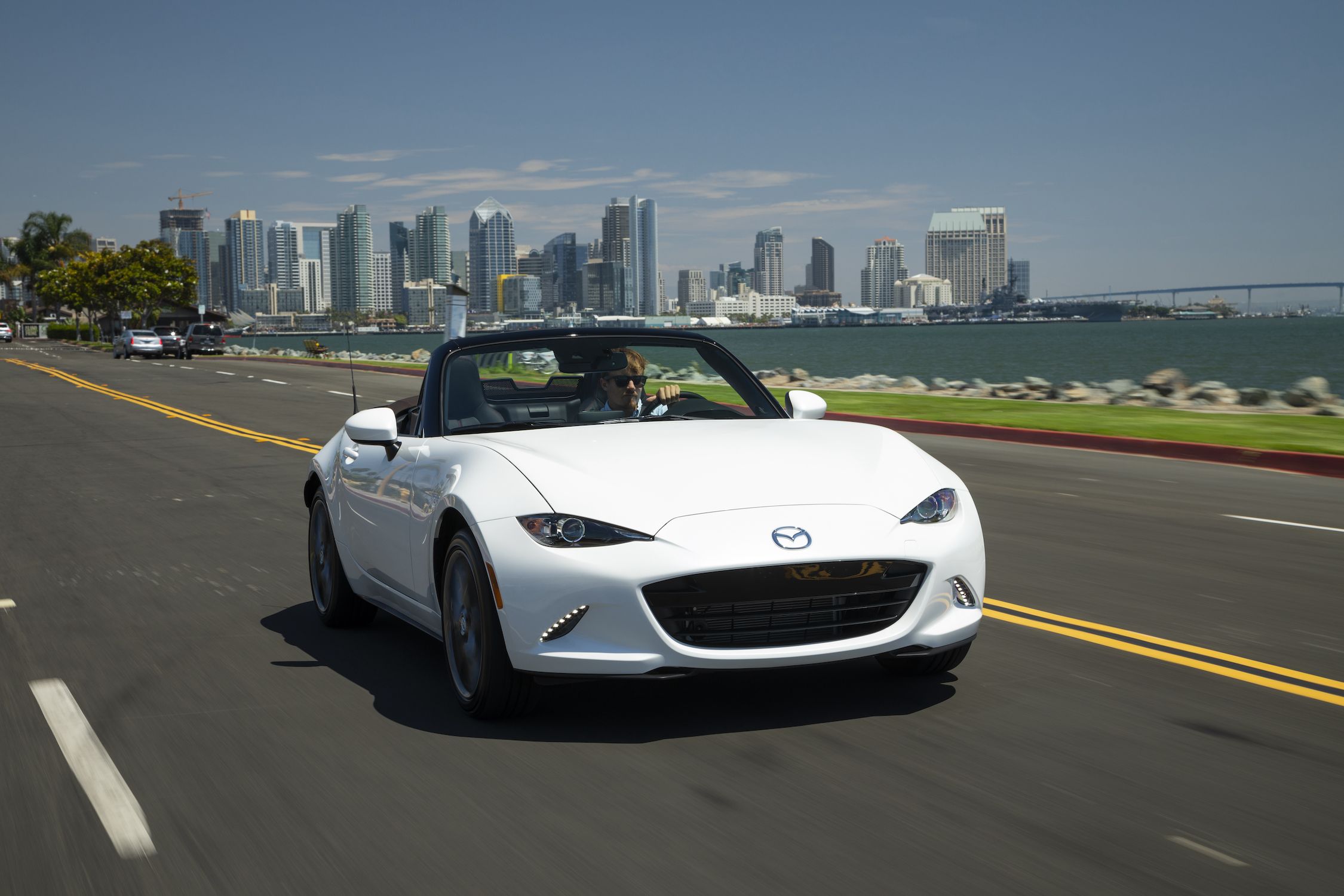 2023 mazda mx5 miata driving a coastal highway