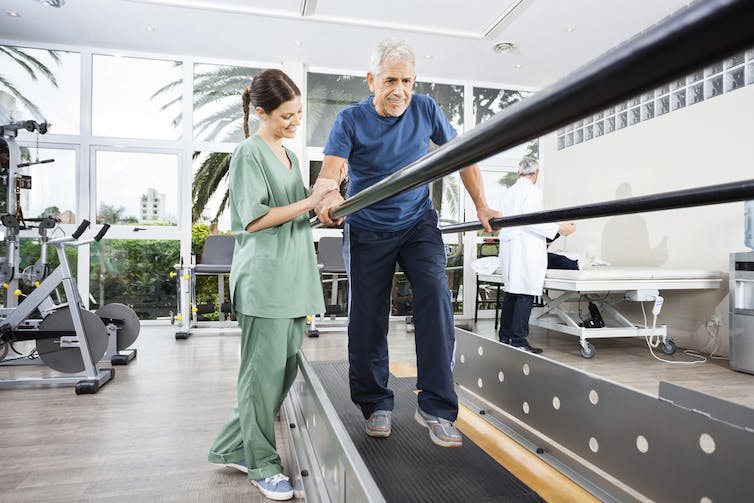 A person does walking rehab exercises.