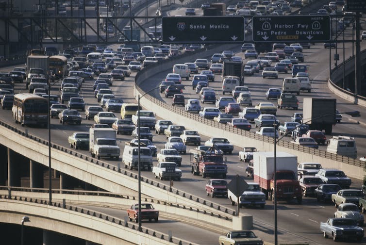 A 1970s-era photo of cars on a freeway with 'Santa Monica' on the sign.