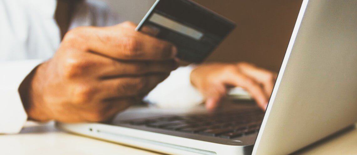 Man entering credit card details on computer