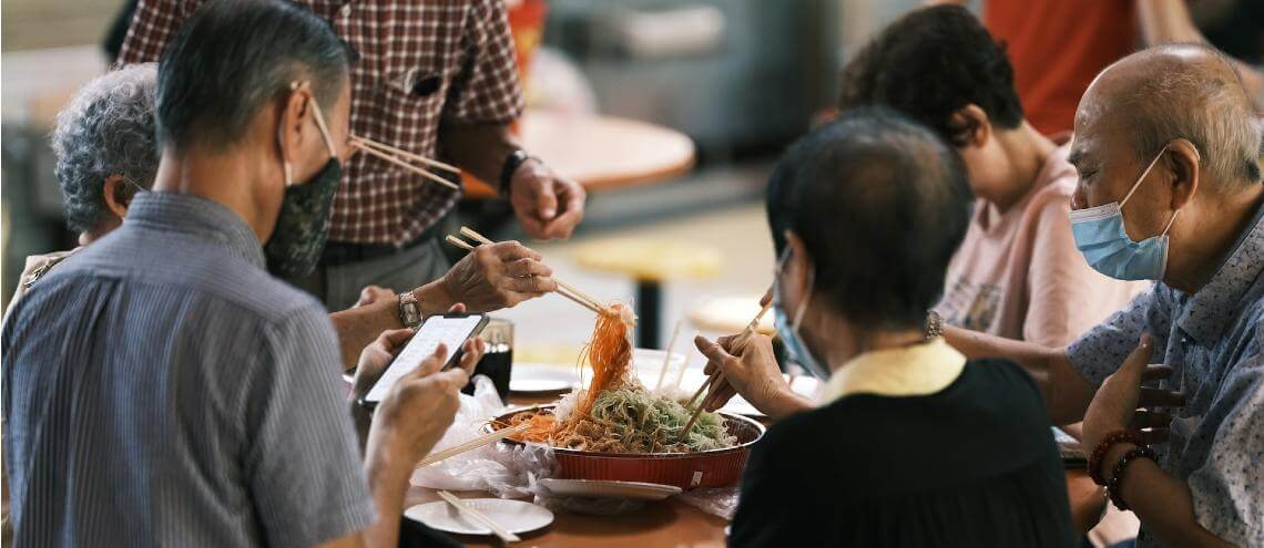 Singaporeans sharing meal with face masks