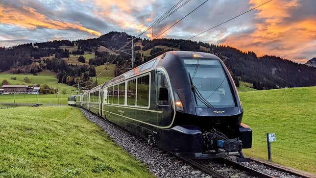 A photo of the new Swiss trains rolling through a field. 