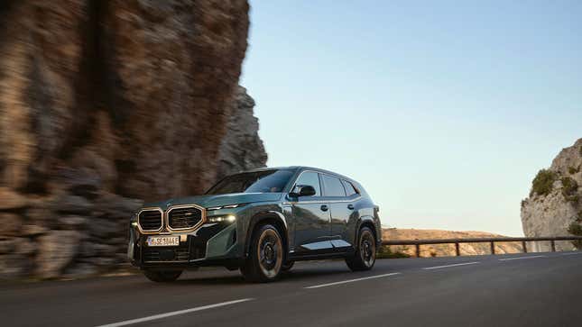 A photo of a BMW XM driving on a highway. 