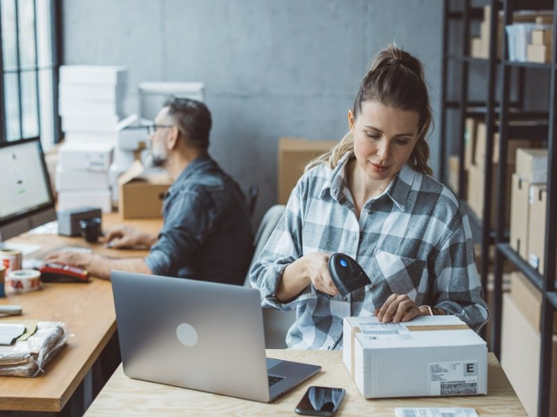 Small business owners working at their company.