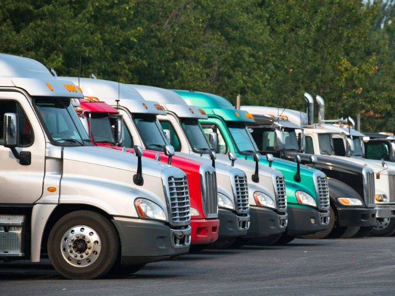 Big rig trucks parked in a fleet facility