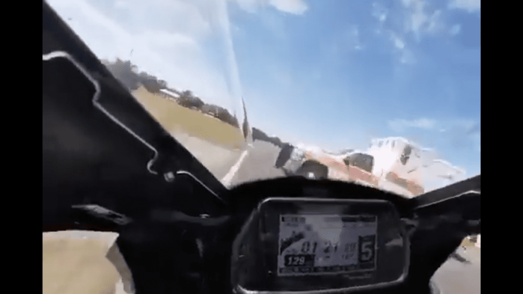 Watch a Motorcycle Racer Barely Miss an Ambulance Crossing a Hot Track