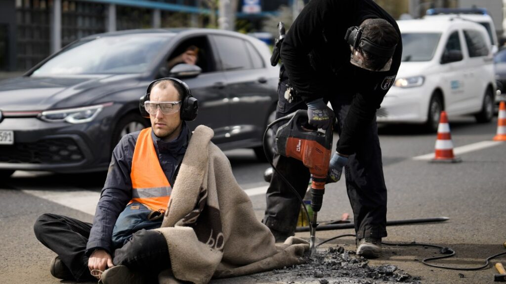 Dozens of climate protesters glue themselves to roadways, block Berlin rush hour