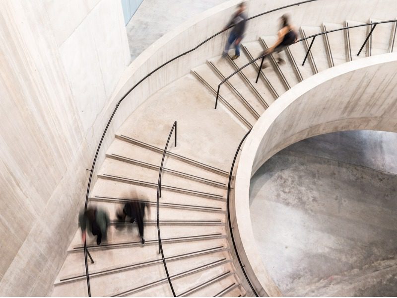 Blurred Motion of People Walking on Spiral Staircase