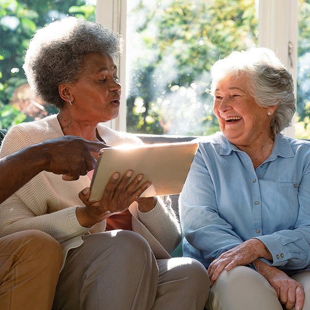 Two women on a sofa.