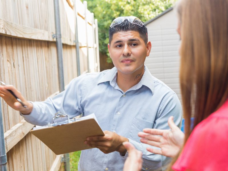 Claims adjuster explaining repairs to homeowner