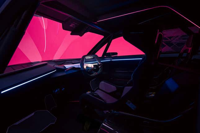 a dimly lit interior view of the Alpine A290_β concept showing the driver's view of the steering wheel; there are no screens