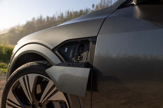 The charge door is open on a gray 2024 Audi Q8 E-Tron Sportback.