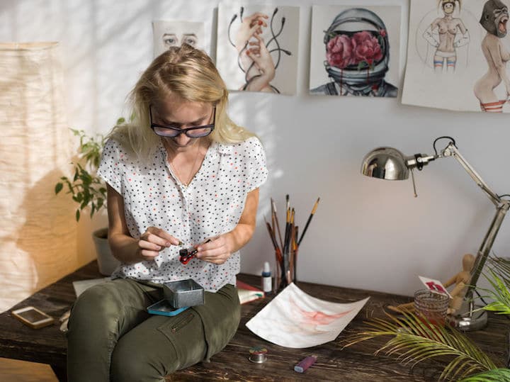 Woman putting weed in a pipe