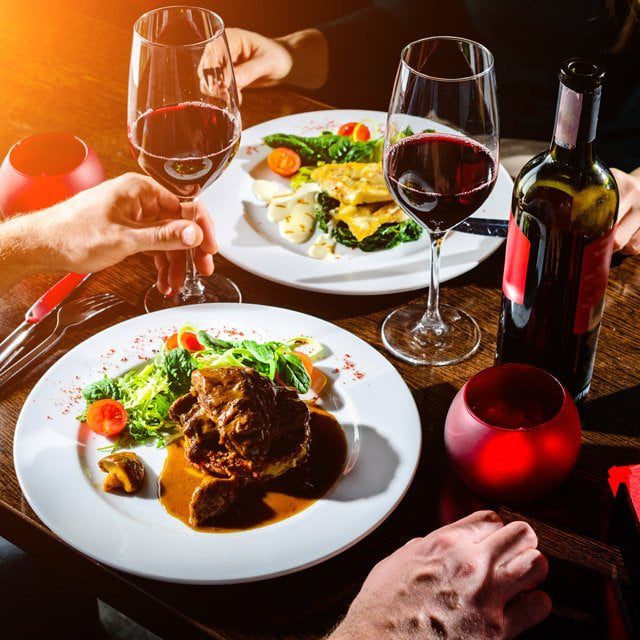 A couple eating steak at a restaurant