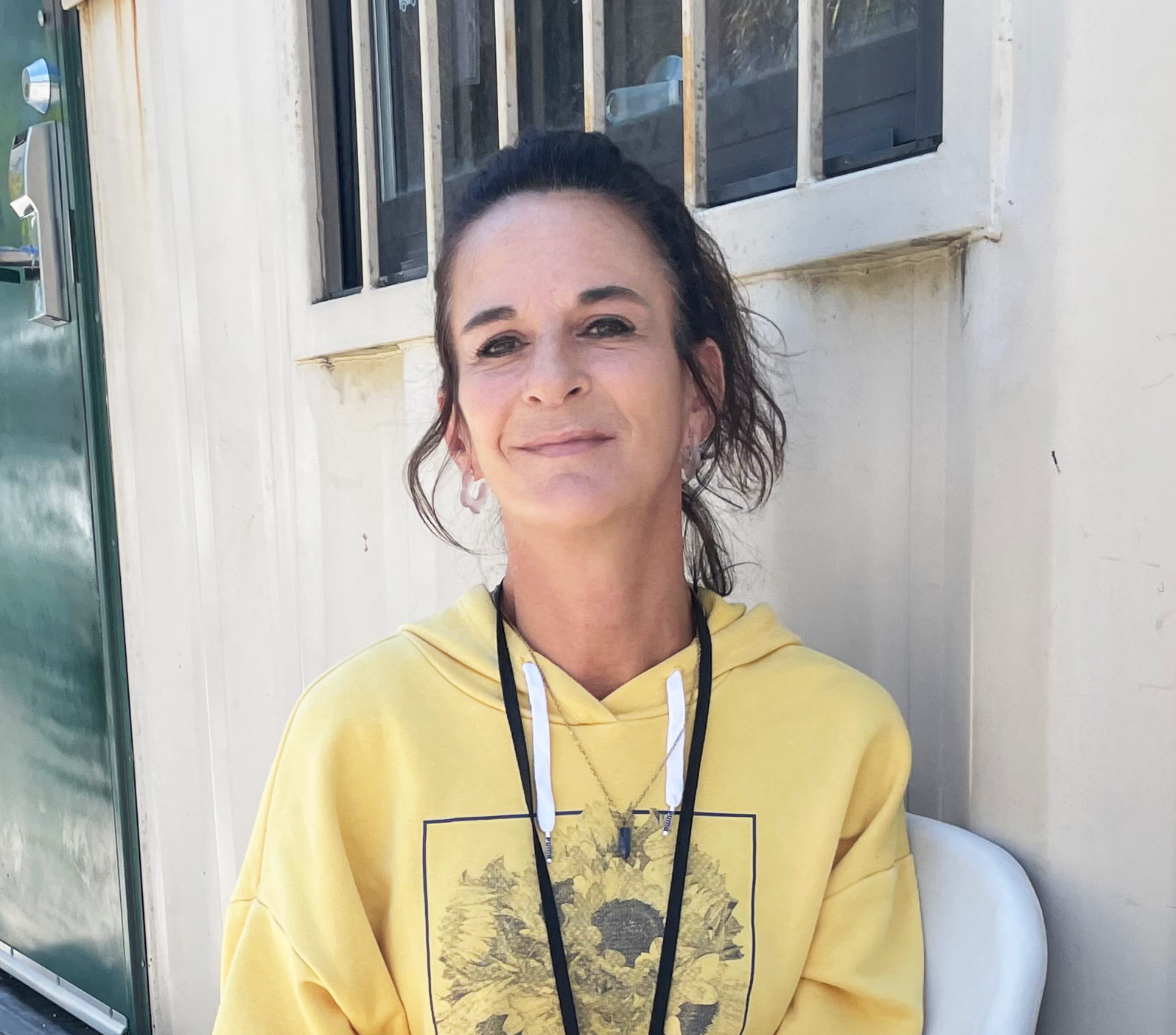 A photo of a woman sitting outside.