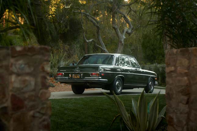 A green 1970 Mercedes, rear three quarter view