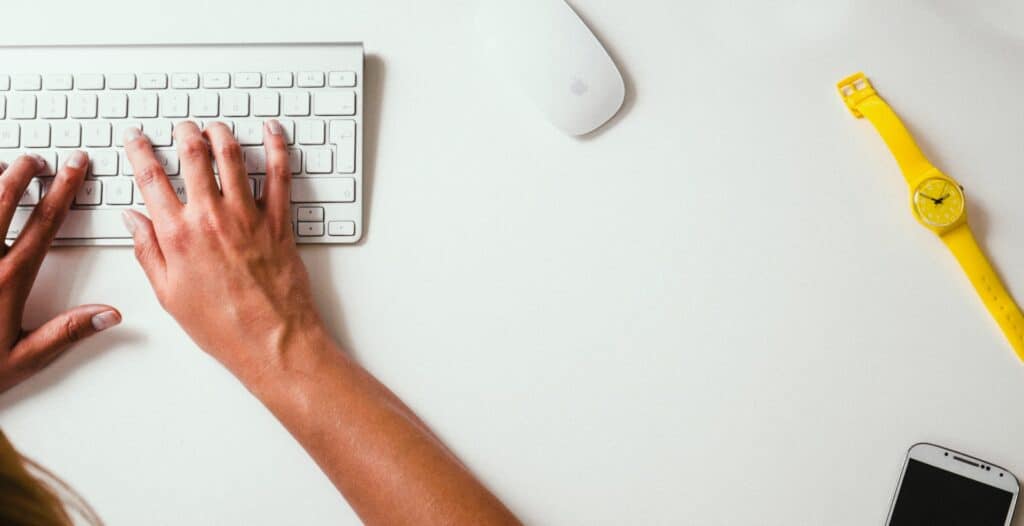 image shows hands on a computer keyboard (not all residents are allowed to moonlight)