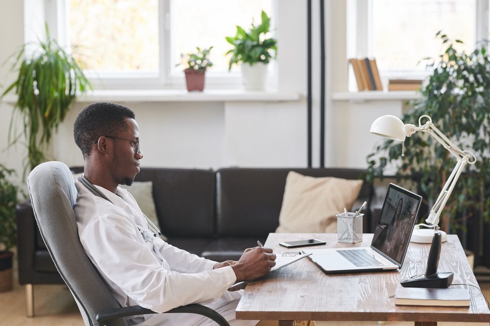 young african american doctor working on a laptop (searching moonlighting opportunities for residents)