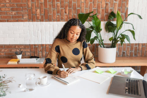 Close-up of concentrated african american project event manager woman working from cool cowork space