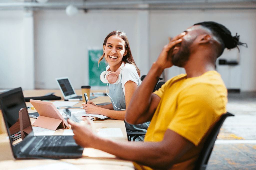 Co-workers having fun while working in a office.