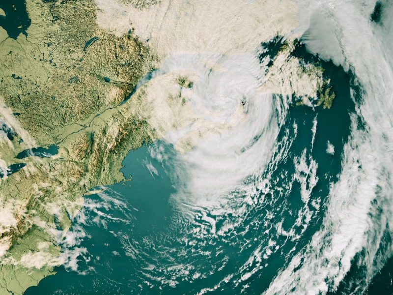 3D render of a topographic map of the US East Coast and the Gulf of St. Lawrence with the clouds from September 24, 2022's Category 4 Major Hurricane Fiona over Nova Scotia, Canada.