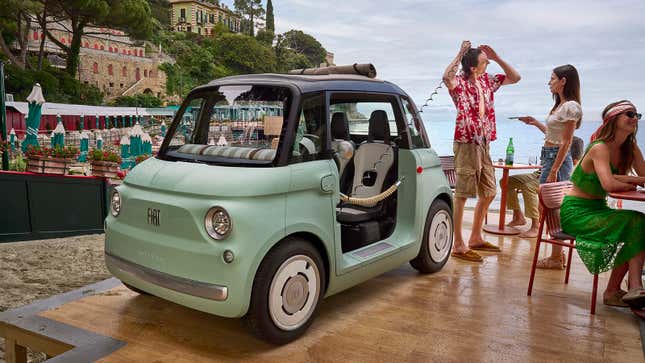 Image of someone showering using the Fiat Topolino's optional shower attachment