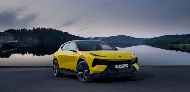 The 2024 Lotus Eletre S in yellow parked in front of a reservoir at dusk